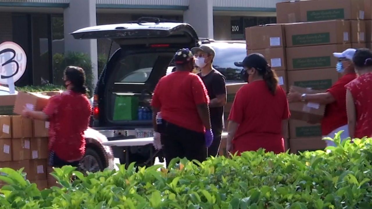 Volunteers with UNITE HERE Local 737 distribute food to affected hospitality workers. (File)