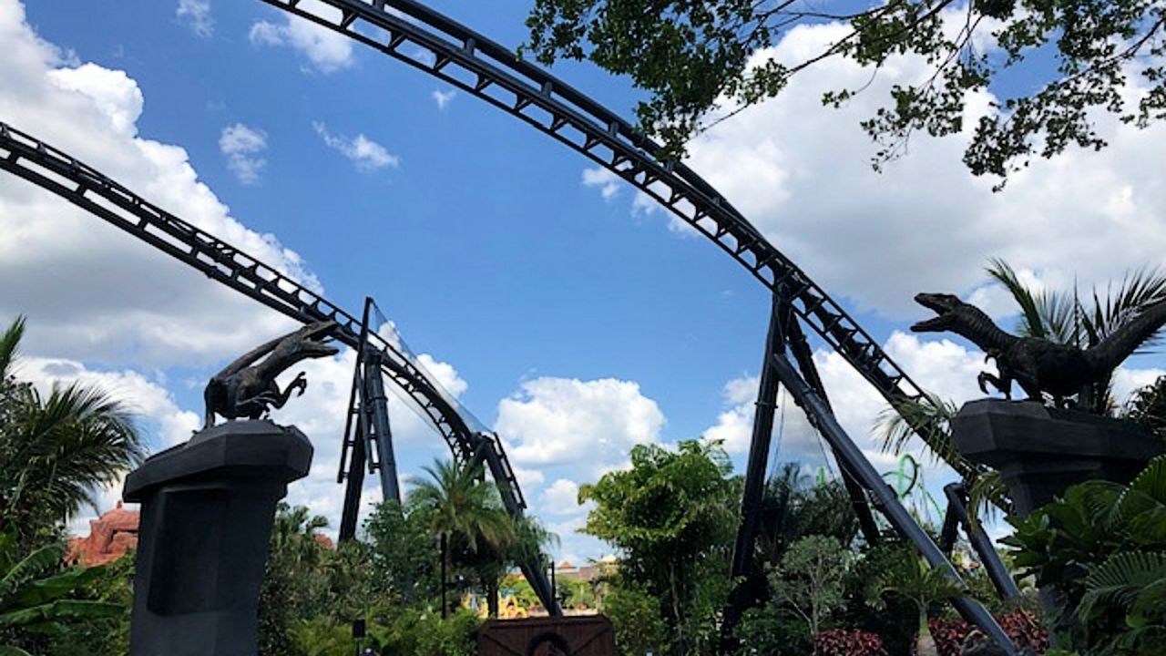 A pair of raptors near the entrance to Jurassic World VelociCoaster(Spectrum News/Ashley Carter)