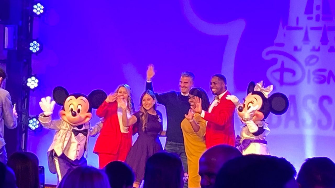 Walt Disney World ambassadors Ali Manion (left) and Raevon Redding (right) pose for pictures with the new ambassadors Serena Arvizu and Shannon Smith-Conrad during a ceremony at EPCOT on Friday. (Spectrum News/Ashley Carter)