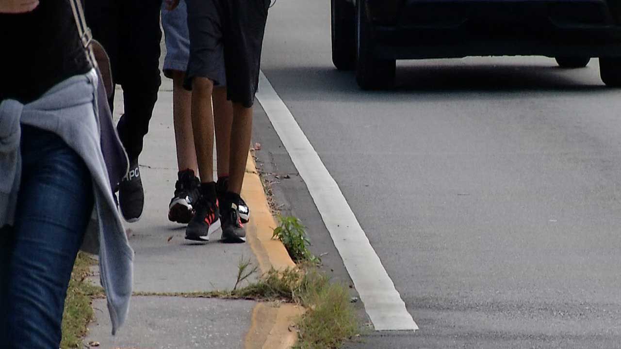Take a look at just how close students are forced to walk near traffic on the narrow sidewalk. 