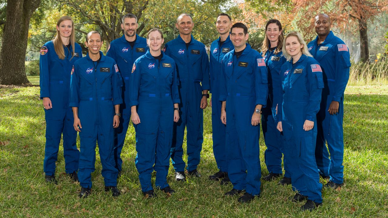 NASA announced its 2021 Astronaut Candidate Class on Dec. 6, 2021. The 10 candidates, pictured here at NASA’s Johnson Space Center in Houston are (alternating back to front): U.S. Air Force Maj. Nichole Ayers, Christopher Williams, U.S. Marine Corps Maj. (retired.) Luke Delaney, U.S. Navy Lt. Cmdr. Jessica Wittner, U.S. Air Force Lt. Col. Anil Menon, U.S. Air Force Maj. Marcos Berríos, U.S. Navy Cmdr. Jack Hathaway, Christina Birch, U.S. Navy Lt. Deniz Burnham, and Andre Douglas.