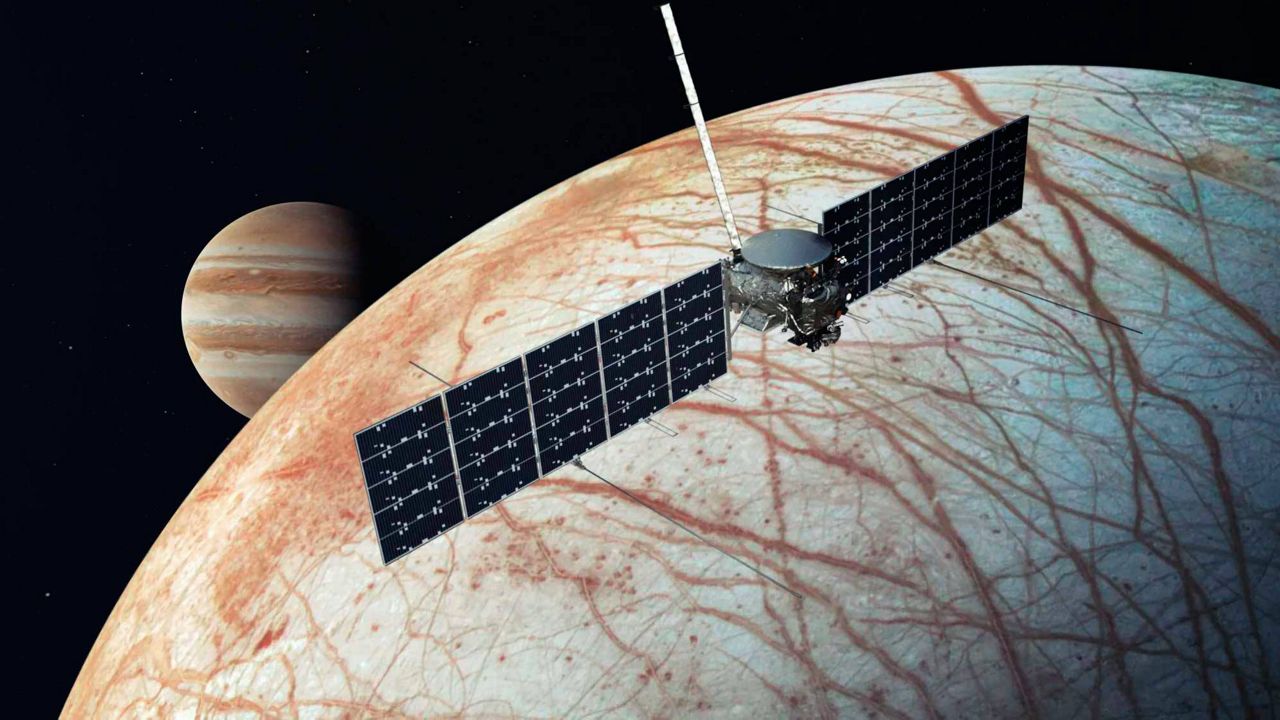 This illustration provided by NASA depicts the Europa Clipper spacecraft over the moon, Europa, with Jupiter at background left. (NASA/JPL-Caltech via AP)