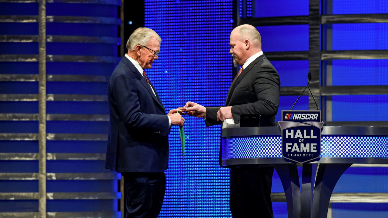 Coy Gibbs, right, presents the Hall of Fame ring to his father, NASCAR Hall of Fame inductee Joe Gibbs, during the induction ceremony in Charlotte, N.C., on Jan. 31, 2020. (AP Photo/Mike McCarn, File)