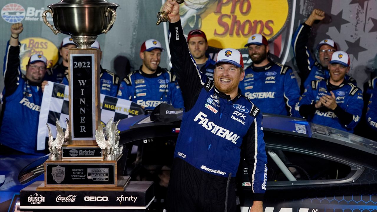 Chris Buescher celebrates with his trophy and sword after winning a NASCAR Cup Series auto race at Bristol Motor Speedway Saturday, Sept. 17, 2022, in Bristol, Tenn. (AP Photo/Mark Humphrey)