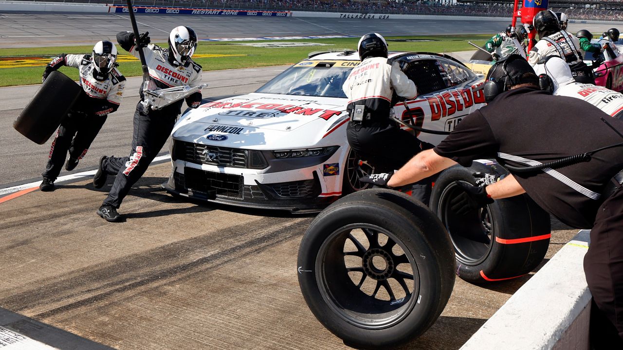 Crew members for driver Austin Cindric change tires during a NASCAR Cup Series auto race at Talladega Superspeedway, Sunday, Oct. 6, 2024, in Talladega, Ala. (AP File Photo/ Butch Dill)