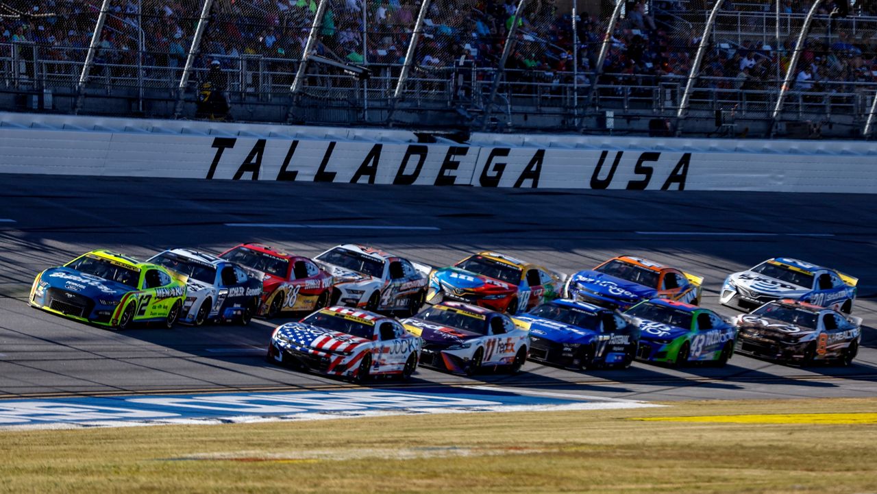 Ryan Blaney (12) leads the field through the tri-oval during a NASCAR Cup Series auto race Sunday, Oct. 2, 2022, in Talladega, Ala. (AP Photo/Butch Dill)