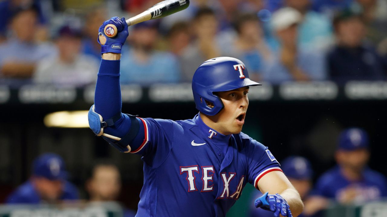 Texas Rangers' Nathaniel Lowe follows through on a hit during the sixth inning of a baseball game against the Kansas City Royals in Kansas City, Mo., Monday, June 27, 2022. (AP Photo/Colin E. Braley)