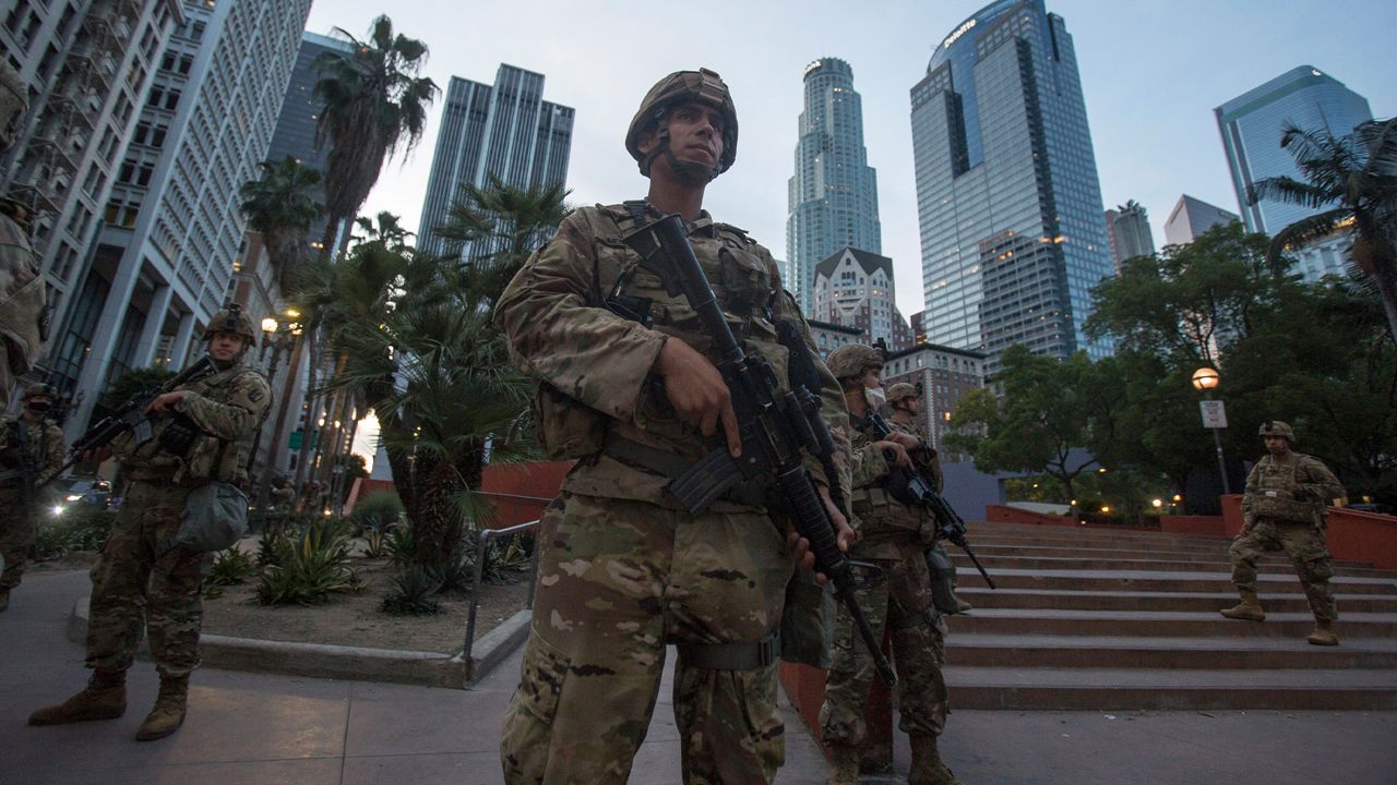 Members of California National Guard stand guard in Pershing Square, Sunday, May 31, 2020, in Los Angeles. (AP Photo/Ringo H.W. Chiu)