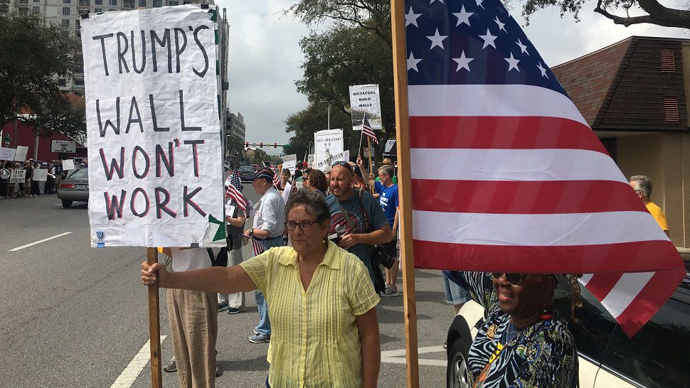 In St. Petersburg, a crowd gathered outside Congressman Charlie Crist's 1st Avenue North office to protest. (Eddie Jackson/Spectrum Bay News 9)
