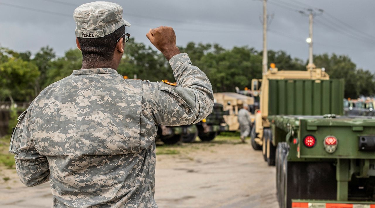 Florida National Guardsman Sgt. Eliezer Perez ground-guides an A5 truck as the 12-18th Transportation Company ot of West Palm Beach prepares to distribute hurricane supplies on Sept. 2, 2019. (File Photo)