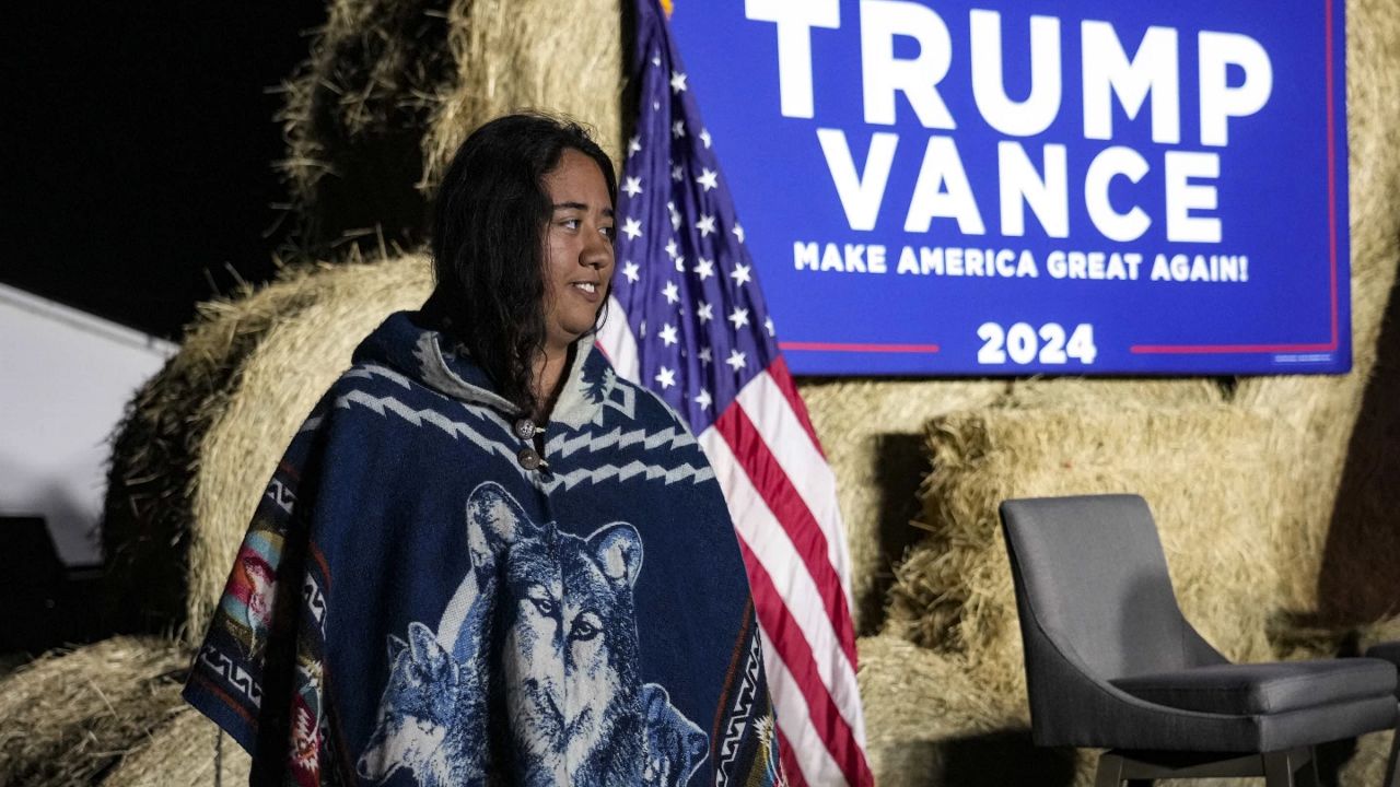 A Native American woman walks by the stage during a campaign event in support of Republican presidential nominee former President Donald Trump, Friday, Oct. 18, 2024, in Red Springs, N.C. (AP Photo/David Yeazell)