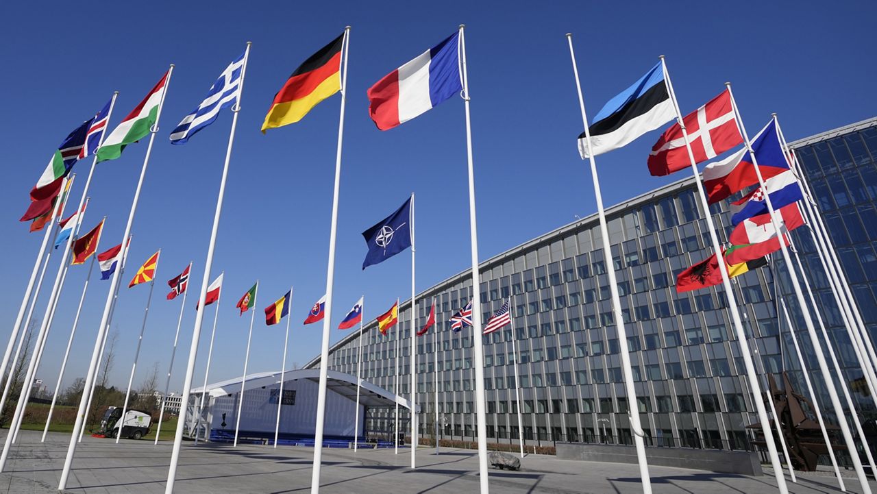 An empty flagpole stands between the national flags of France and Estonia outside NATO headquarters in Brussels on Monday. Finland awaits an official green light to become the 31st member of the world's biggest security alliance as NATO foreign ministers prepare to meet in Brussels on Tuesday and Wednesday. (AP Photo/Virginia Mayo)