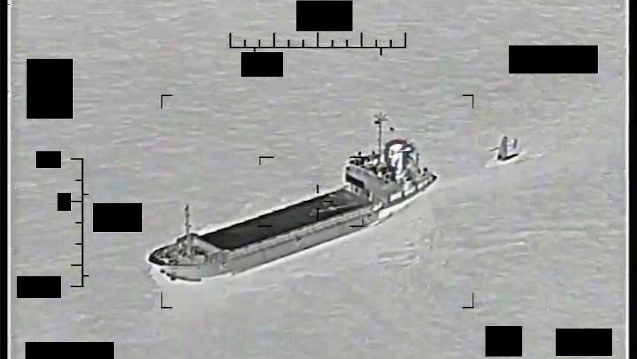 This photo released by the U.S. Navy shows the Iranian Revolutionary Guard ship Shahid Bazair, left, towing a U.S. Navy Saildrone Explorer in the Persian Gulf on Tuesday, Aug. 30, 2022. (U.S. Navy via AP)