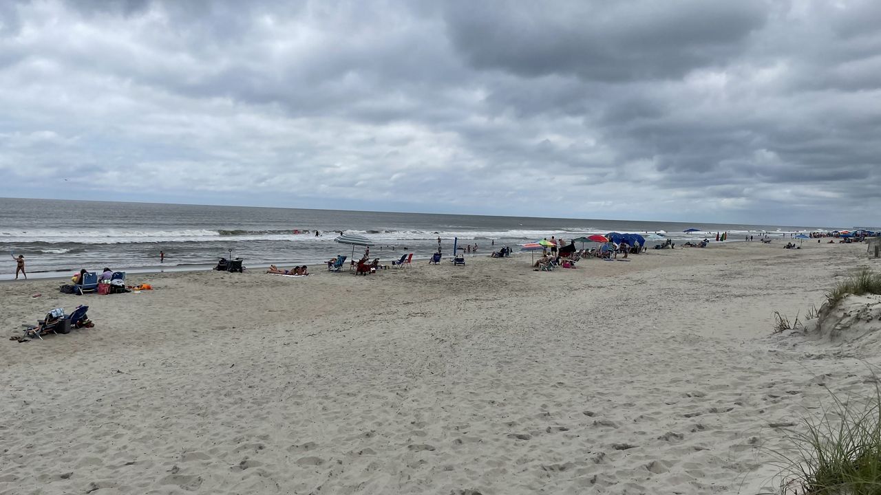 A North Carolina man drowned in the water off Oak Island and a handful of other swimmers in the area required assistance Sunday, authorities said.