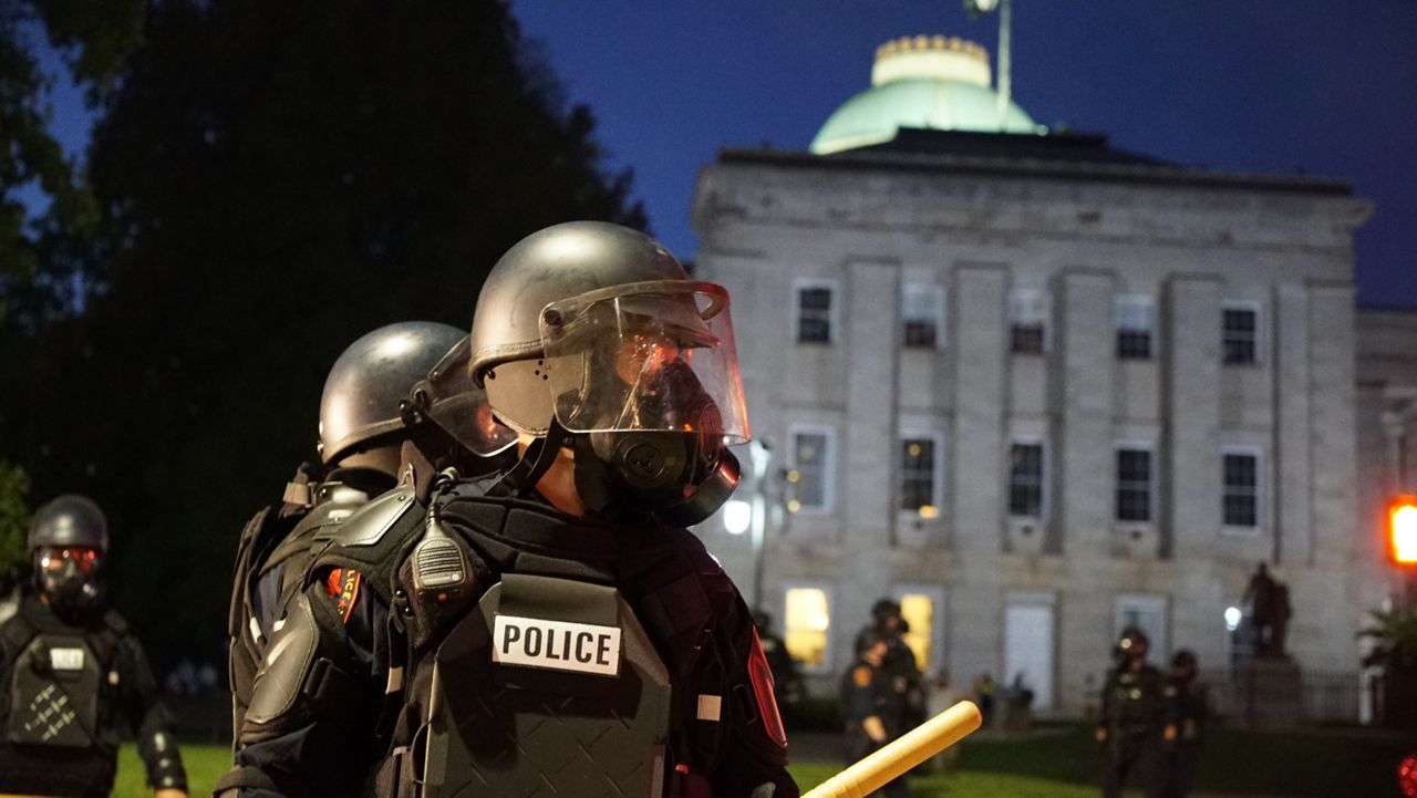 Police in riot gear protect the old state capitol building in Raleigh, N.C., on May 31, 2020. A North Carolina civil rights group filed a federal lawsuit on Tuesday, April 11, 2023, challenging a new state law that will increase punishments for violent protests in response to the nationwide 2020 racial injustice demonstrations ignited by George Floyd’s murder. (AP Photo/Allen G. Breed, File)