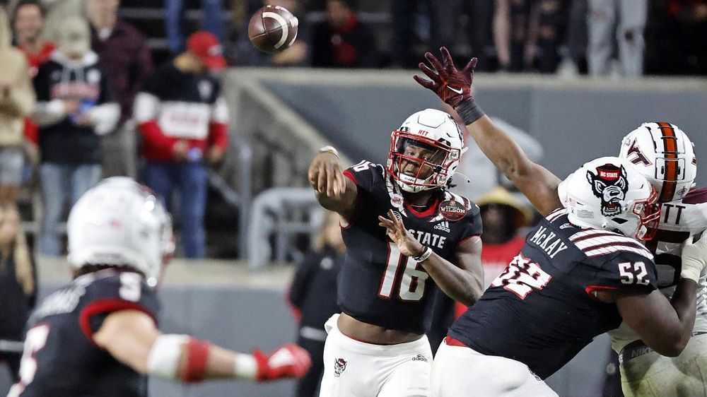 North Carolina State quarterback MJ Morris (16) throws the ball to Thayer Thomas (5) during the second half of an NCAA college football game against Virginia Tech in Raleigh, N.C., Thursday, Oct. 27, 2022. (AP Photo/Karl B DeBlaker)