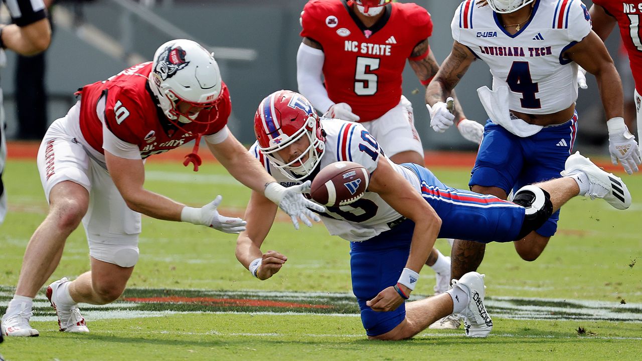 N.C. State's Caden Fordham (10) gathers in a fumble from Louisiana Tech's Jack Turner (10) during the first half of an NCAA college football game in Raleigh, N.C., Saturday, Sept. 14, 2024. (AP Photo/Karl B DeBlaker)