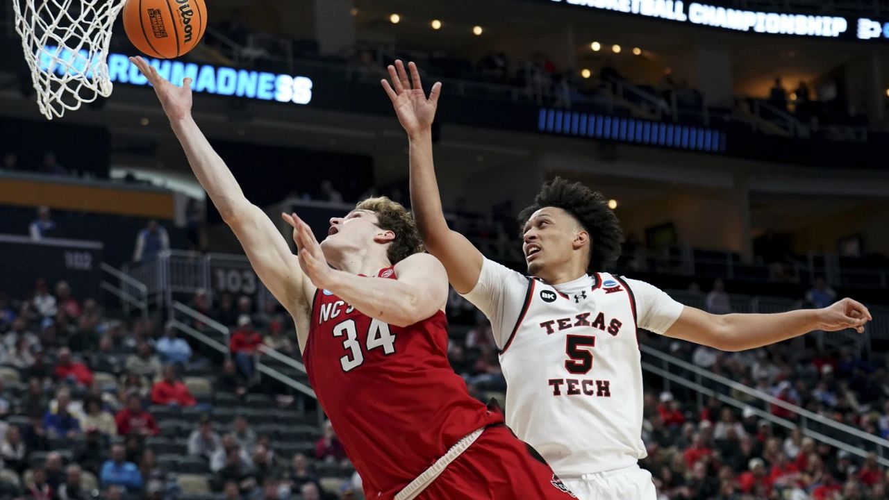 North Carolina State's Ben Middlebrooks (34) shoots against Texas Tech's Darrion Williams (5) during the second half of a college basketball game in the first round of the men's NCAA Tournament on Thursday, March 21, 2024, in Pittsburgh. (AP Photo/Matt Freed)`
