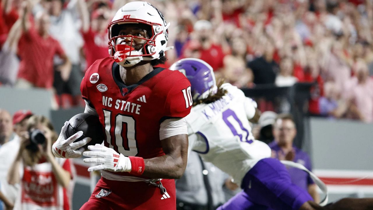 North Carolina State wide receiver Kevin Concepcion (10) looks toward the scoreboard as he scores a touchdown against Western Carolina during the second half of an NCAA college football game in Raleigh, N.C., Thursday, Aug. 29, 2024. (AP Photo/Karl B DeBlaker)