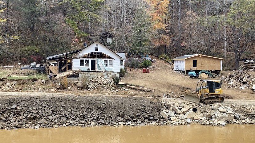 Work is underway to repair a road damaged by Hurricane Helene in Yancey County. (Spectrum News 1/Natalie Mooney)