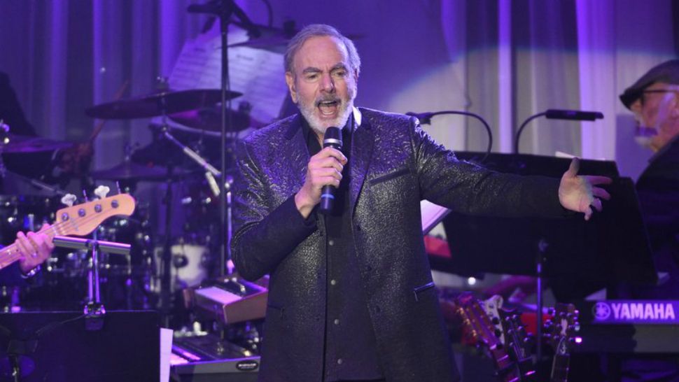 This Feb. 11, 2010 file photo shows Neil Diamond performing at the Clive Davis and The Recording Academy Pre-Grammy Gala at the Beverly Hilton Hotel in Beverly Hills, Calif. Diamond is retiring form touring after he says he was diagnosed with Parkinson’s disease. Days shy of his 77th birthday, the rock legend is canceling his tour dates in Australia and New Zealand for March. He was on his 50th anniversary tour. (Photo by Chris Pizzello/Invision/Ap)