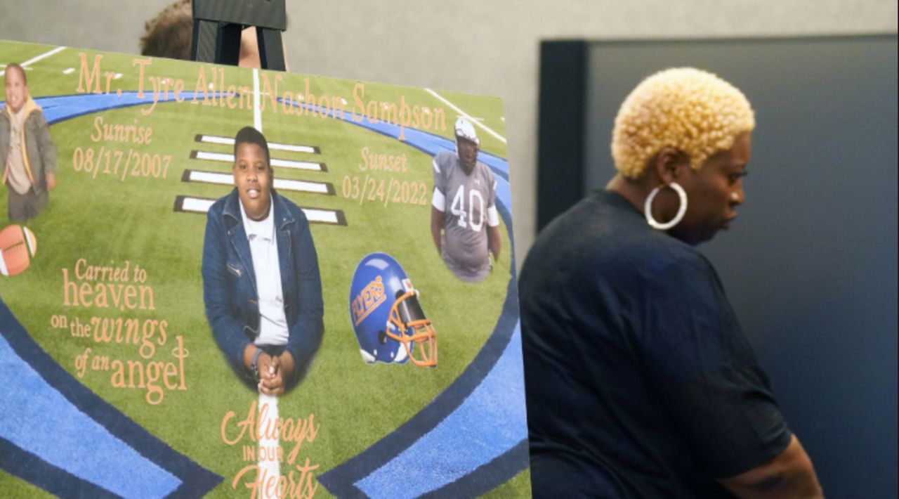 Nekia Dodd, mother of Tyre Sampson, leaves a press conference, past a sign of her son after a wrongful death lawsuit was filed on behalf of the family of Sampson in St. Louis on Tuesday, April 26, 2022. Sampson, a 6-foot 2-inch, 300 pound, 14 year old, fell 430 feet to his death from the Free Fall attraction at Orlando's Icon Park on March 24, 2022. Haggard says a seat belt should have been used because of the boy's size. Photo by Bill Greenblatt/UPI