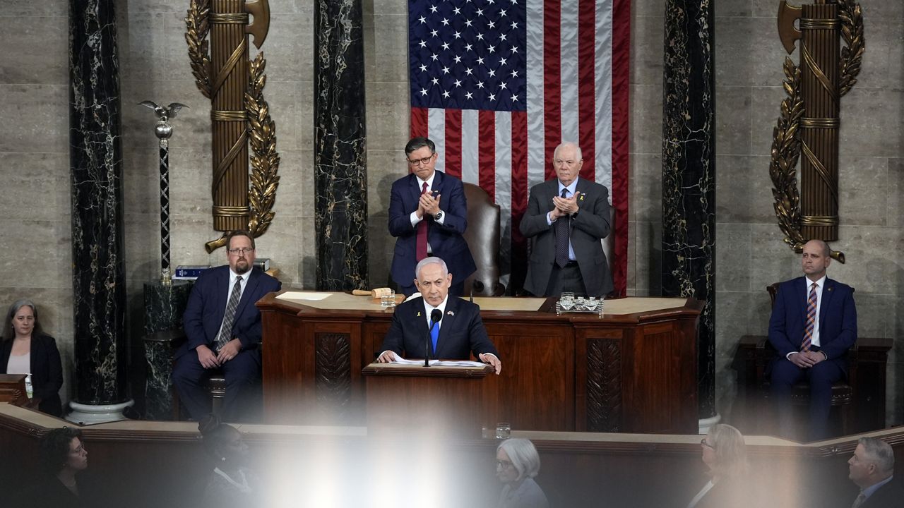 Israeli Prime Minister Benjamin Netanyahu speaks to a joint meeting of Congress at the Capitol in Washington, Wednesday, July 24, 2024, as House Speaker Mike Johnson of La., and Senate Foreign Relations Chair Ben Cardin, D-Md., listen. (AP Photo/Julia Nikhinson)