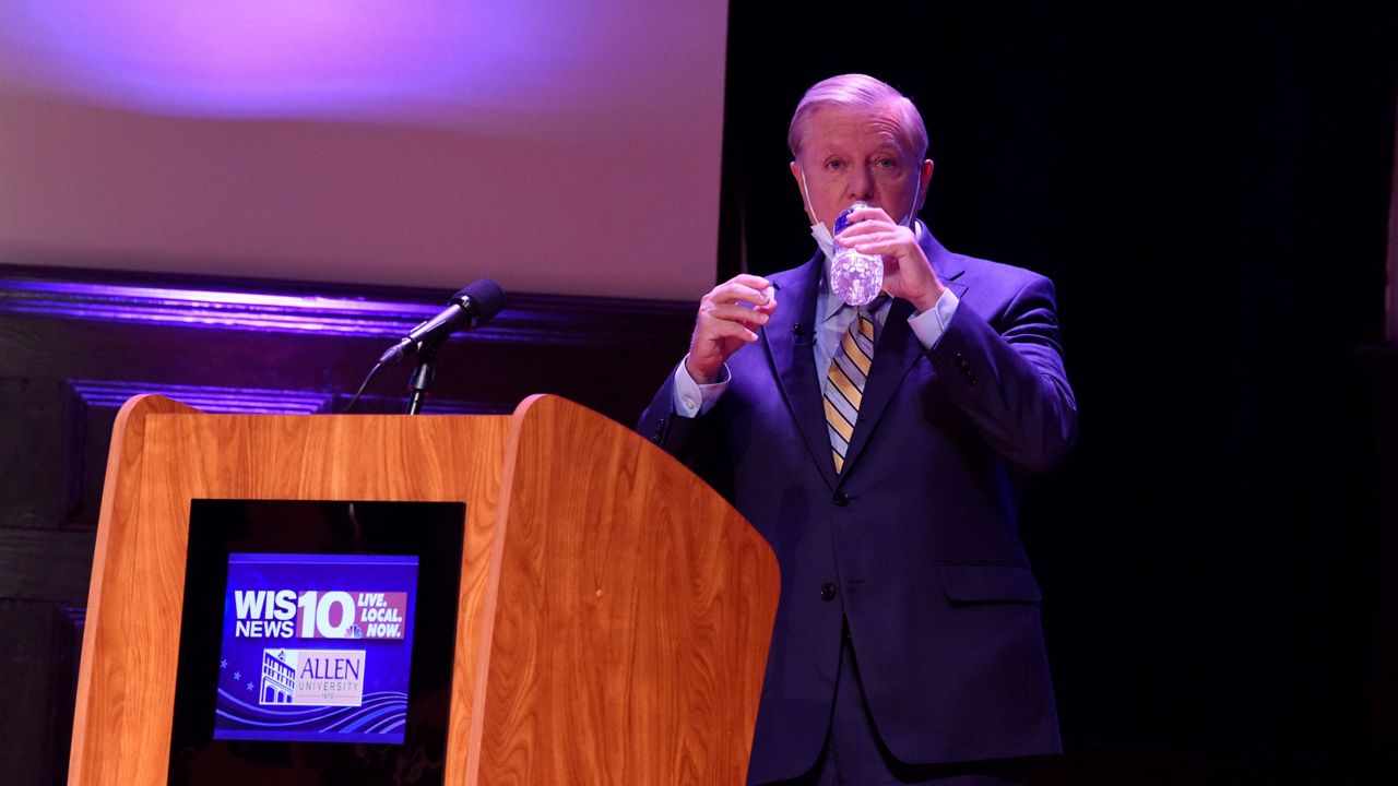 U.S. Sen. Lindsey Graham drinks water before his first debate with Democratic challenger Jaime Harrison, Saturday, Oct. 3, 2020, at Allen University in Columbia, S.C. (AP Photo/Meg Kinnard)