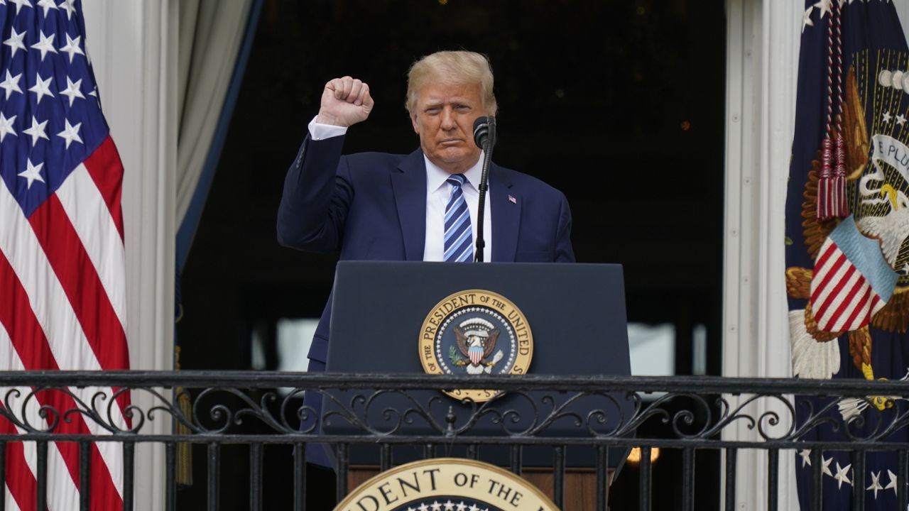 President Donald Trump speaks from the Blue Room Balcony of the White House to a crowd of supporters, Saturday, Oct. 10, 2020, in Washington. (AP Photo/Alex Brandon)