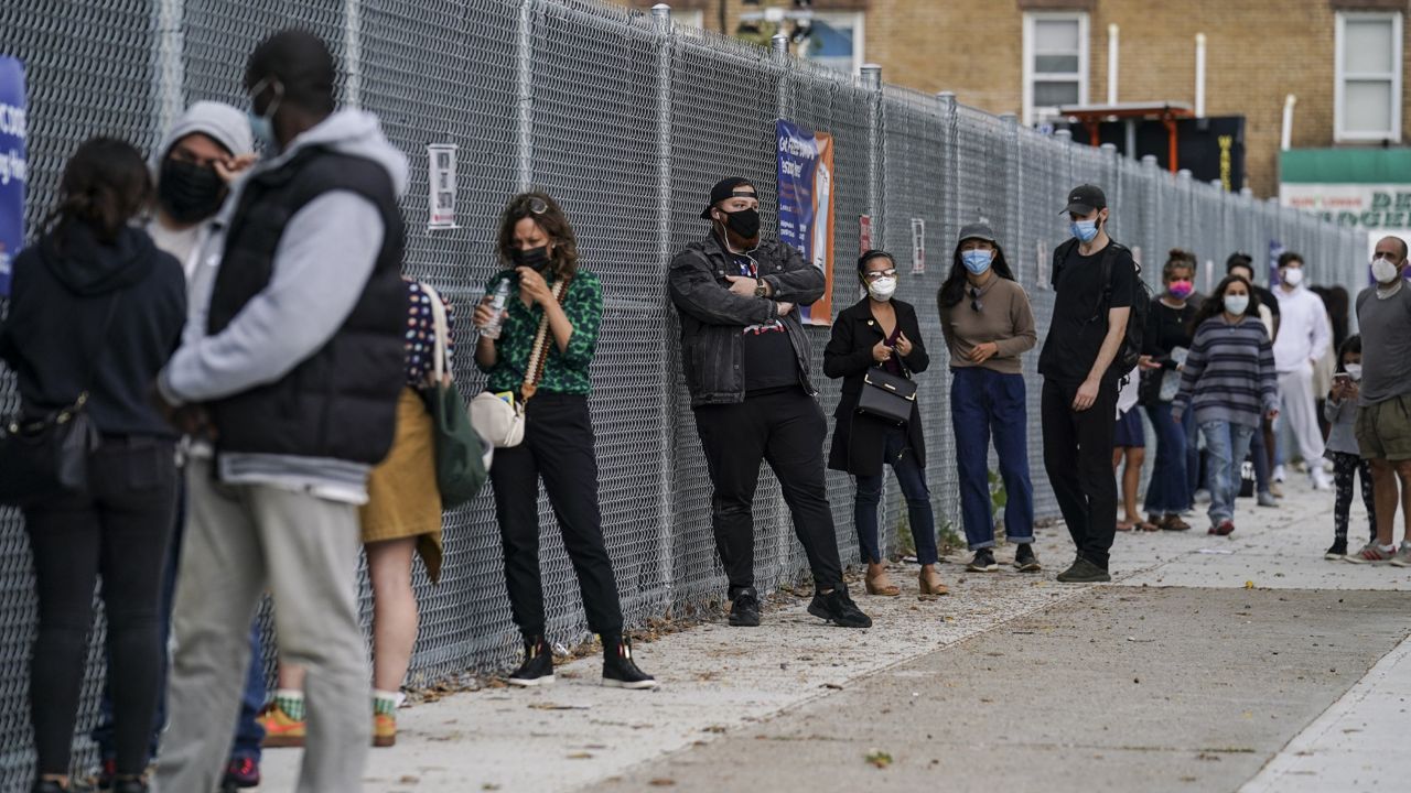 Patients wait on line outside a COVID-19 testing site that provides priority testing for NYC Department of Education staff through NYC Health + Hospitals on Ft. Hamilton Parkway, Wednesday, Oct. 7, 2020, in the Borough Park neighborhood of the Brooklyn borough of New York. (AP Photo/John Minchillo)