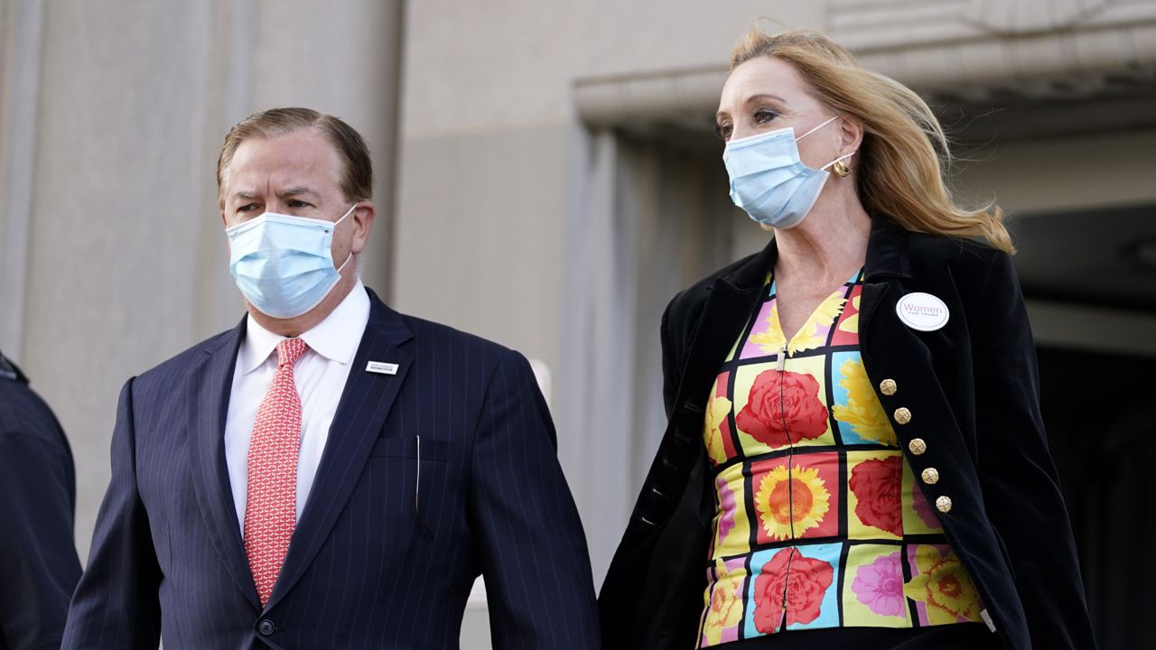 Mark and Patricia McCloskey leave following a court hearing Wednesday, Oct. 14, 2020, in St. Louis.  (AP Photo/Jeff Roberson)