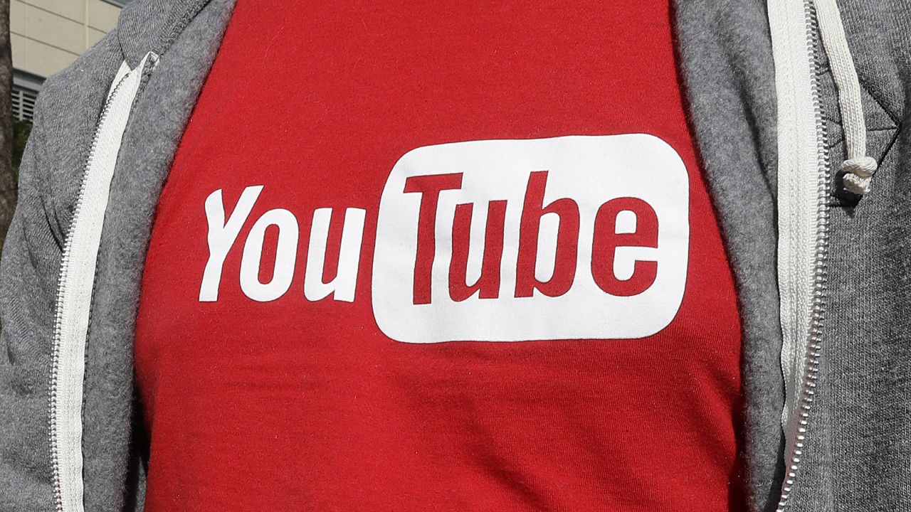 FILE - This April 4, 2018, file photo shows a YouTube logo on a t-shirt worn by a person near a YouTube office building in San Bruno, Calif. (AP Photo/Jeff Chiu, File)