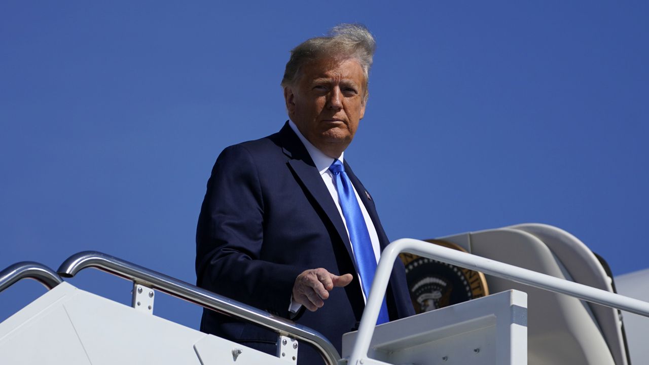 President Donald Trump boards Air Force One for a trip to Greenville, N.C. to attend a campaign rally, Oct. 15, 2020, in Andrews Air Force Base, Md. (AP Photo/Evan Vucci)