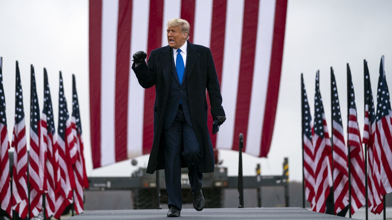 President Donald Trump arrives at Capital Region International Airport for a campaign rally, Tuesday, Oct. 27, 2020, in Lansing, Mich. (AP Photo/Evan Vucci)