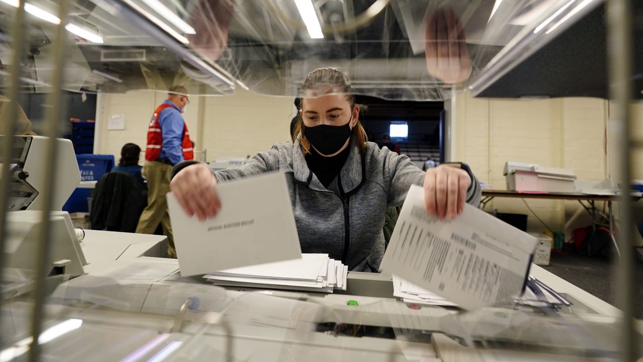 FILE: Chester County, Pa., election worker Kristina Sladek opens mail-in and absentee ballots for the 2020 General Election in the United States at West Chester University, Tuesday, Nov. 3, 2020, in West Chester, Pa. (AP Photo/Matt Slocum)