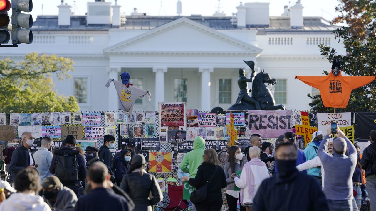 People gather in Black Lives Matter Plaza near the White House in Washington, Wednesday, Nov. 4, 2020. (AP Photo/Susan Walsh)