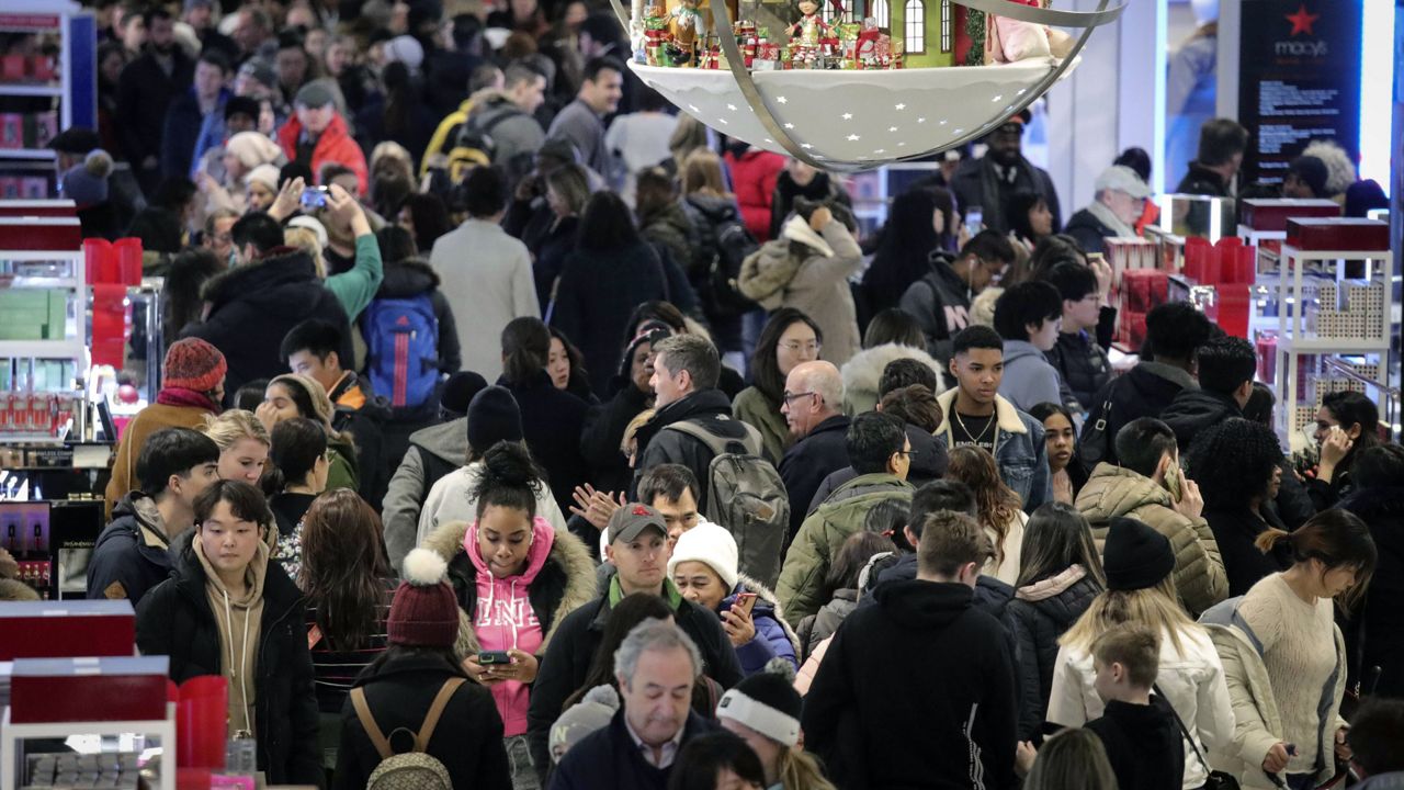 FILE: People shop at Macy's department store during Black Friday shopping, Friday Nov. 29, 2019, in New York. (AP Photo/Bebeto Matthews)