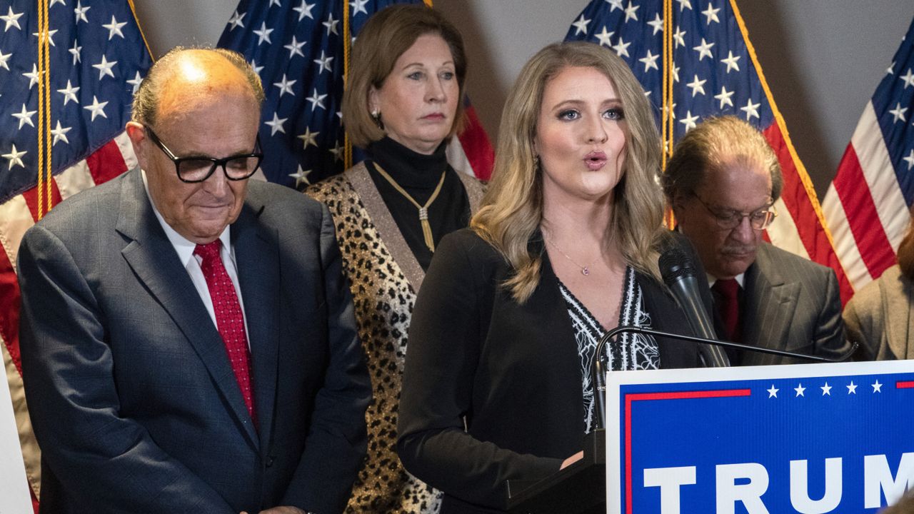 Members of President Donald Trump's legal team, including former Mayor of New York Rudy Giuliani, left, Sidney Powell, and Jenna Ellis, speaking, attend a news conference at the Republican National Committee headquarters, Thursday Nov. 19, 2020, in Washington. (AP Photo/Jacquelyn Martin)