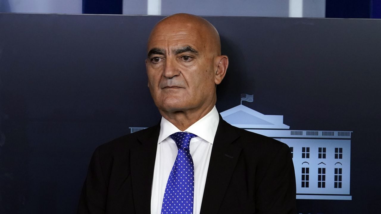 FILE: Dr. Moncef Slaoui, chief adviser to Operation Warp Speed, stands on the podium before President Donald Trump speaks during a news conference in the James Brady Press Briefing Room of the White House, Friday, Sept. 18, 2020, in Washington. (AP Photo/Alex Brandon)