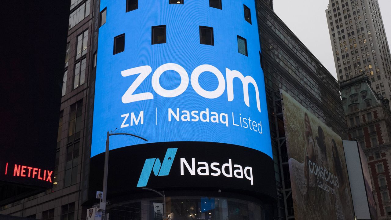 FILE - This April 18, 2019, file photo shows a sign for Zoom Video Communications ahead of the company's Nasdaq IPO in New York. (AP Photo/Mark Lennihan, File)