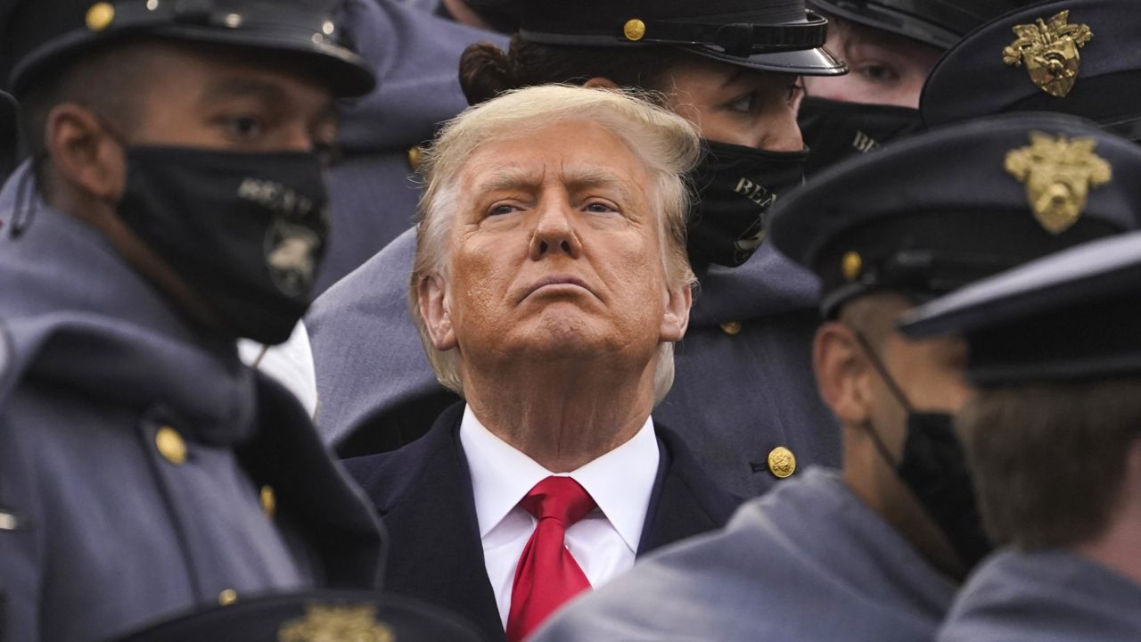 FILE: Surrounded by Army cadets, President Donald Trump watches the first half of the 121st Army-Navy Football Game in Michie Stadium at the United States Military Academy, Saturday, Dec. 12, 2020, in West Point, N.Y. (AP Photo/Andrew Harnik)