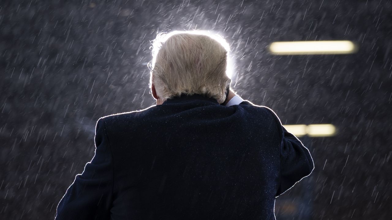 President Donald Trump speaks in the rain during a campaign rally at Capital Region International Airport in Lansing Mich., on Oct. 27, 2020. (AP Photo/Evan Vucci)