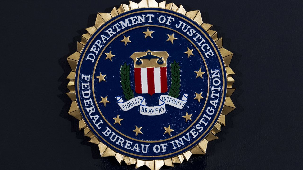 FILE: The FBI seal at a news conference at FBI headquarters in Washington(AP Photo/Jose Luis Magana, File)