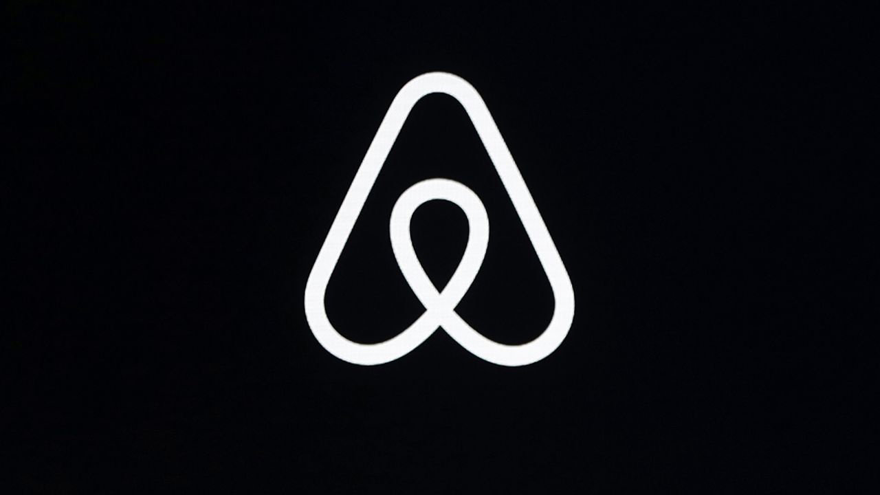 FILE - This Feb. 22, 2018, file photo shows an Airbnb logo during an event in San Francisco. (AP Photo/Eric Risberg, File)
