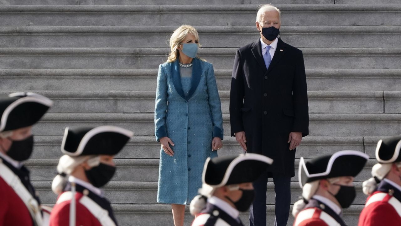 President Joe Biden and his wife Jill Biden watch a military pass in review ceremony on the East Front of the Capitol at the conclusion of the inauguration ceremonies, in Washington, Wednesday, Jan. 20, 2021. (AP Photo/J. Scott Applewhite)