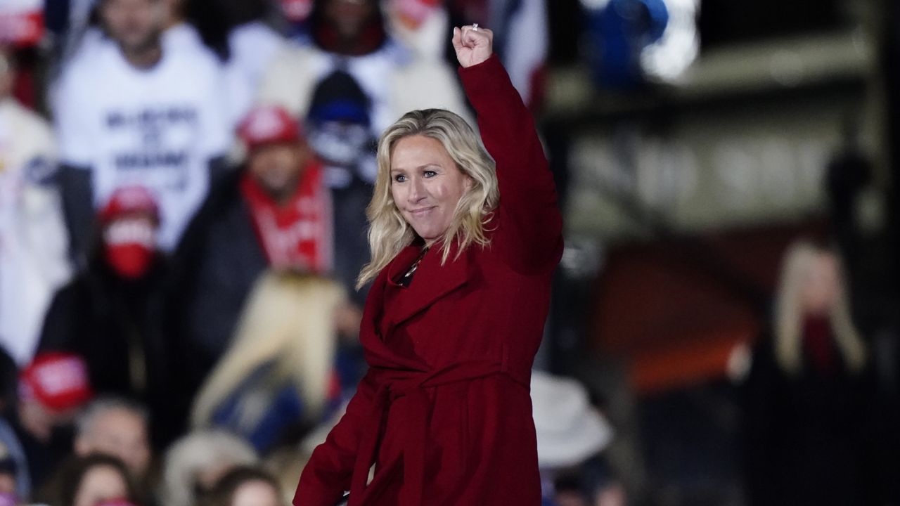 FILE: Rep. Marjorie Taylor Greene, R-Ga., gestures as Donald Trump speaks at a campaign rally Monday, Jan. 4, 2021. (AP Photo/Brynn Anderson)