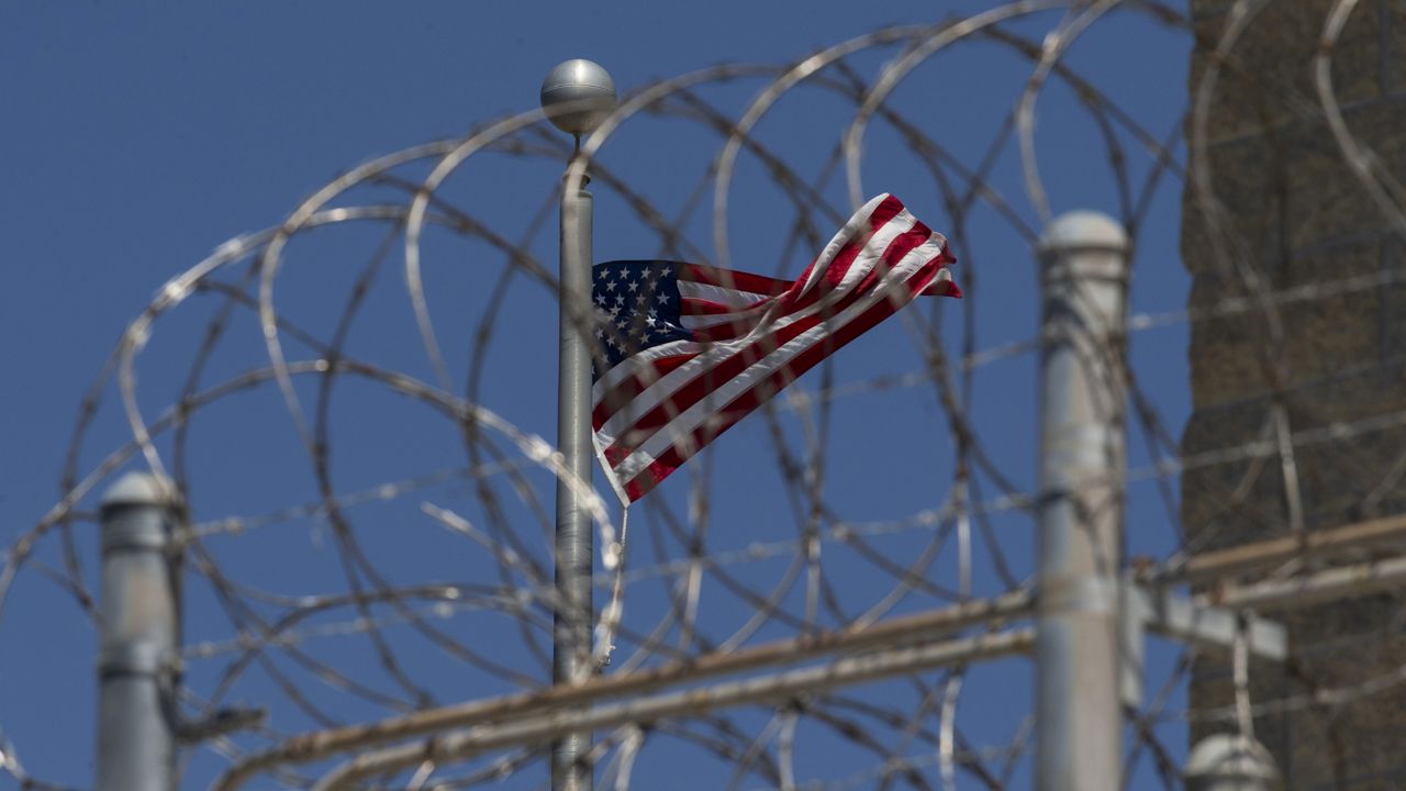 FILE: U.S. flag flies inside the razor wire of the Camp VI detention facility in Guantanamo Bay Naval Base, Cuba. (AP Photo/Alex Brandon)