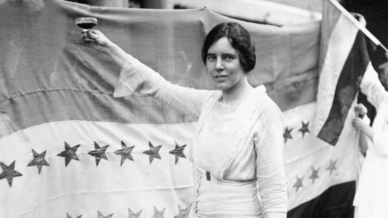 In this Sept. 3, 1920 photo, Alice Paul raises a glass. (Harris & Ewing/Library of Congress via AP)
