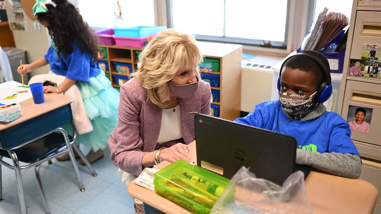 First lady Jill Biden speaks with a student as she tours Benjamin Franklin Elementary School, Wednesday, March 3, 2021 in Meriden, Ct. (Mandel Ngan/Pool via AP)