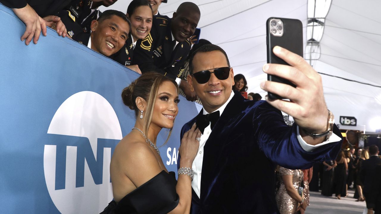 Jennifer Lopez, left, and Alex Rodriguez take a selfie as they arrive at the 26th annual Screen Actors Guild Awards at the Shrine Auditorium & Expo Hall on Sunday, Jan. 19, 2020, in Los Angeles. (Photo by Matt Sayles/Invision/AP)